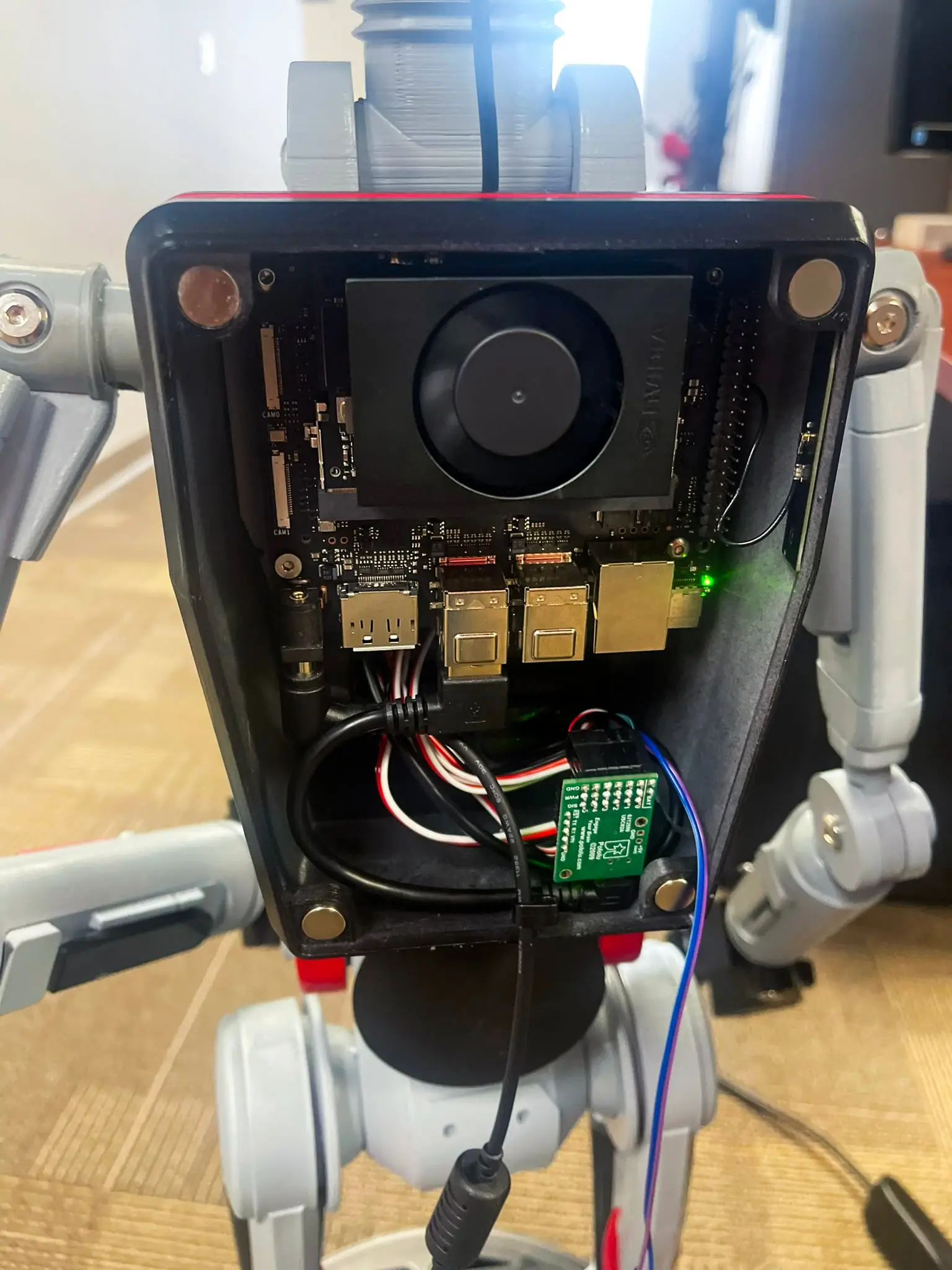 Electronics mounted in the droid's backpack showing the Orin Nano and wiring