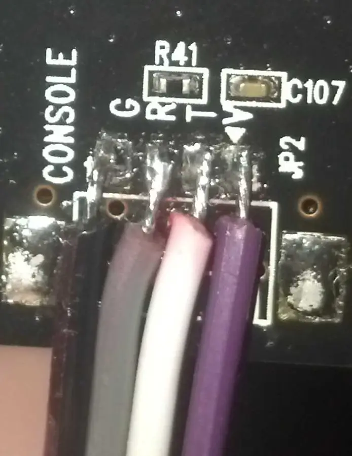 Jumper wires soldered to the UART pins on the PCB for easier interfacing